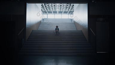 孤独的学童坐着学校楼梯特写镜头男孩隐藏大厅